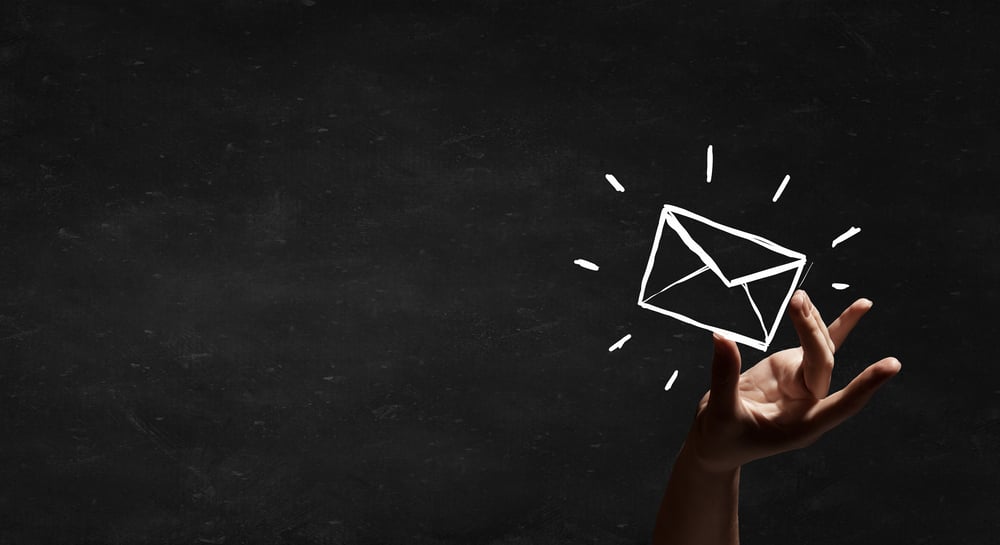 Person hand taking chalk drawn email sign Person hand taking chalk drawn email sign
